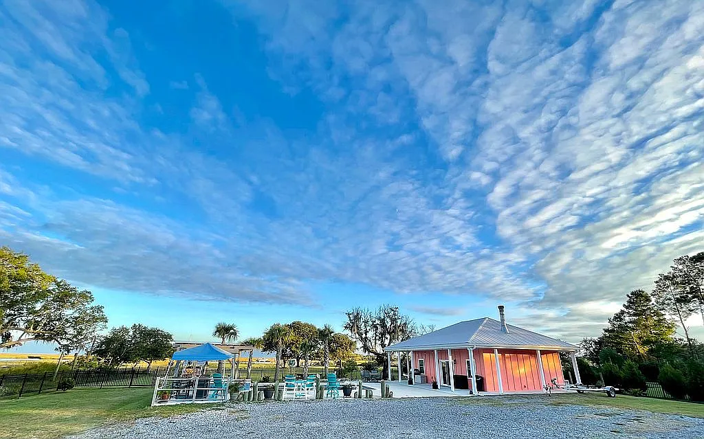 The full compound at blue hour with dramatic Lowcountry sky