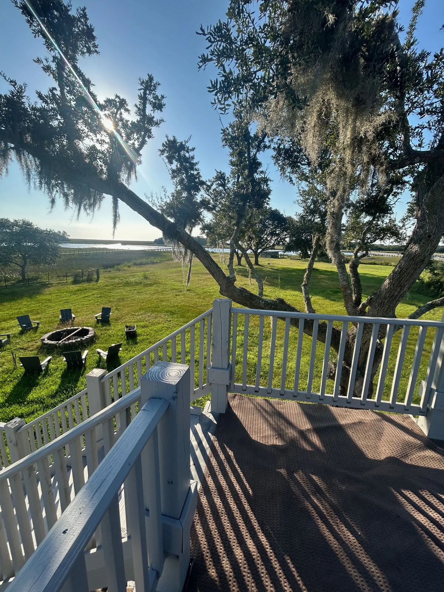 View from the upper deck through Spanish moss down to fire pit and marsh