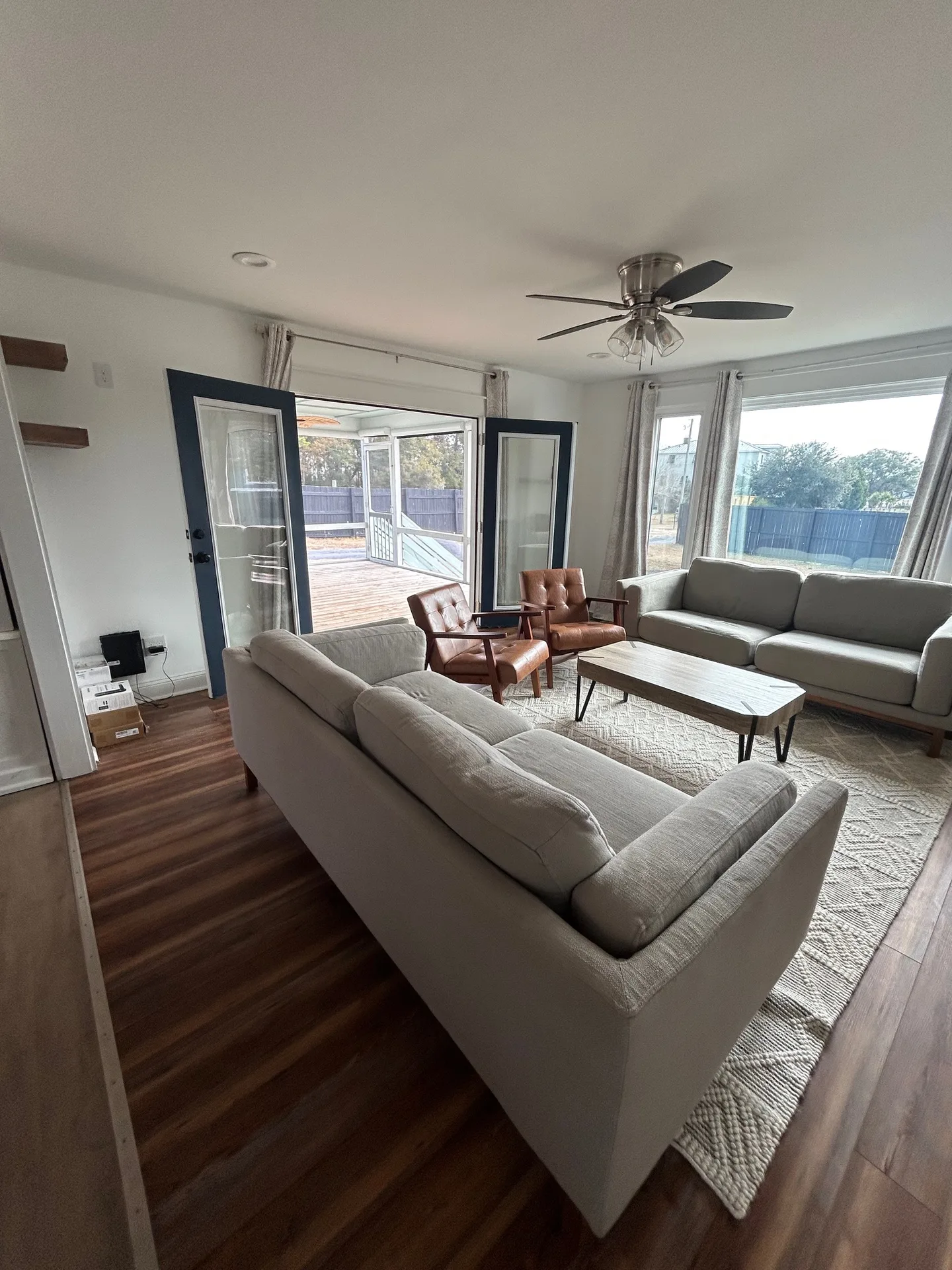Living room with cognac tufted leather chairs as focal points and patterned rug