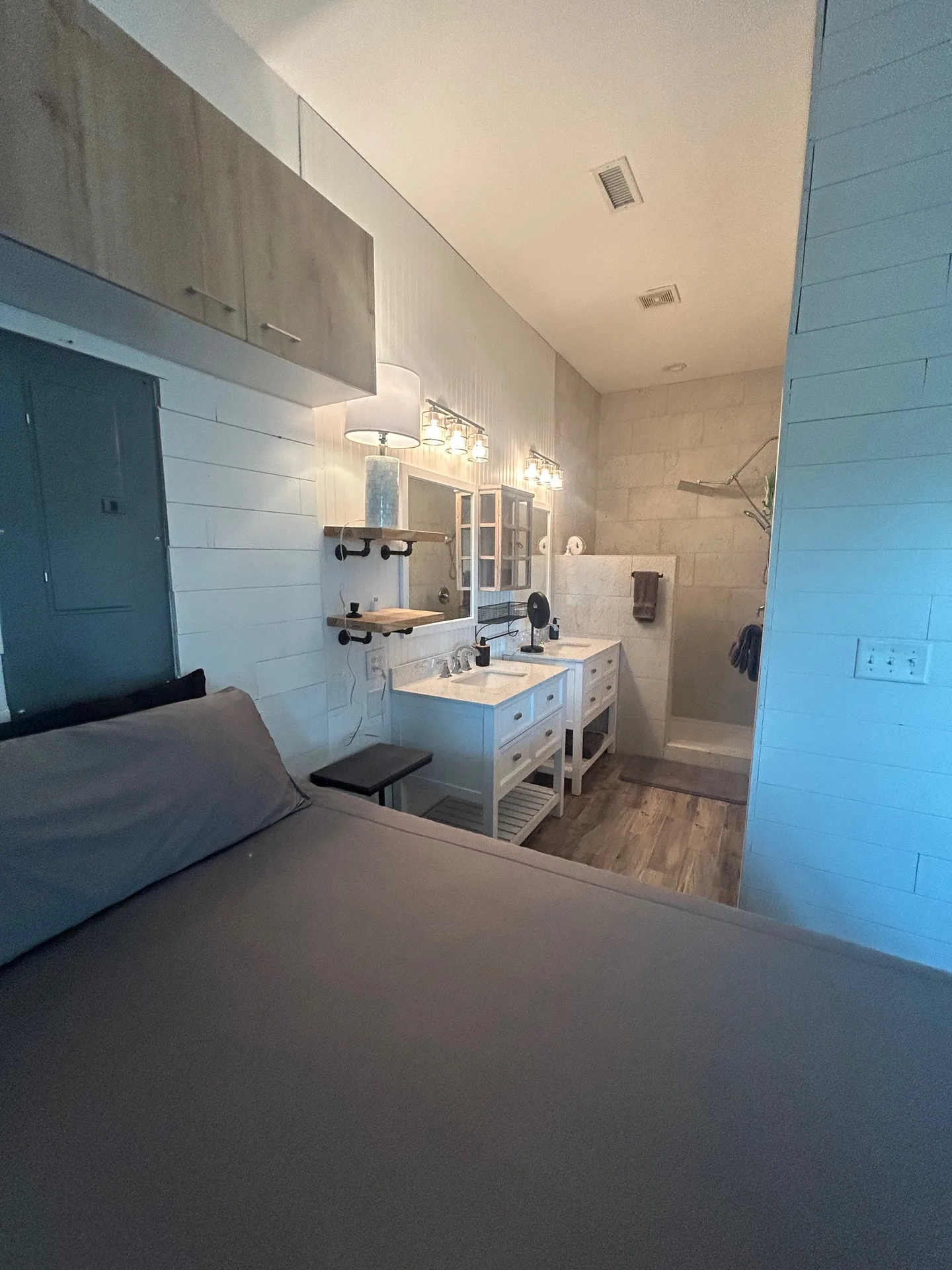 Bedroom looking into en-suite with vanity, medicine cabinet, and handheld shower